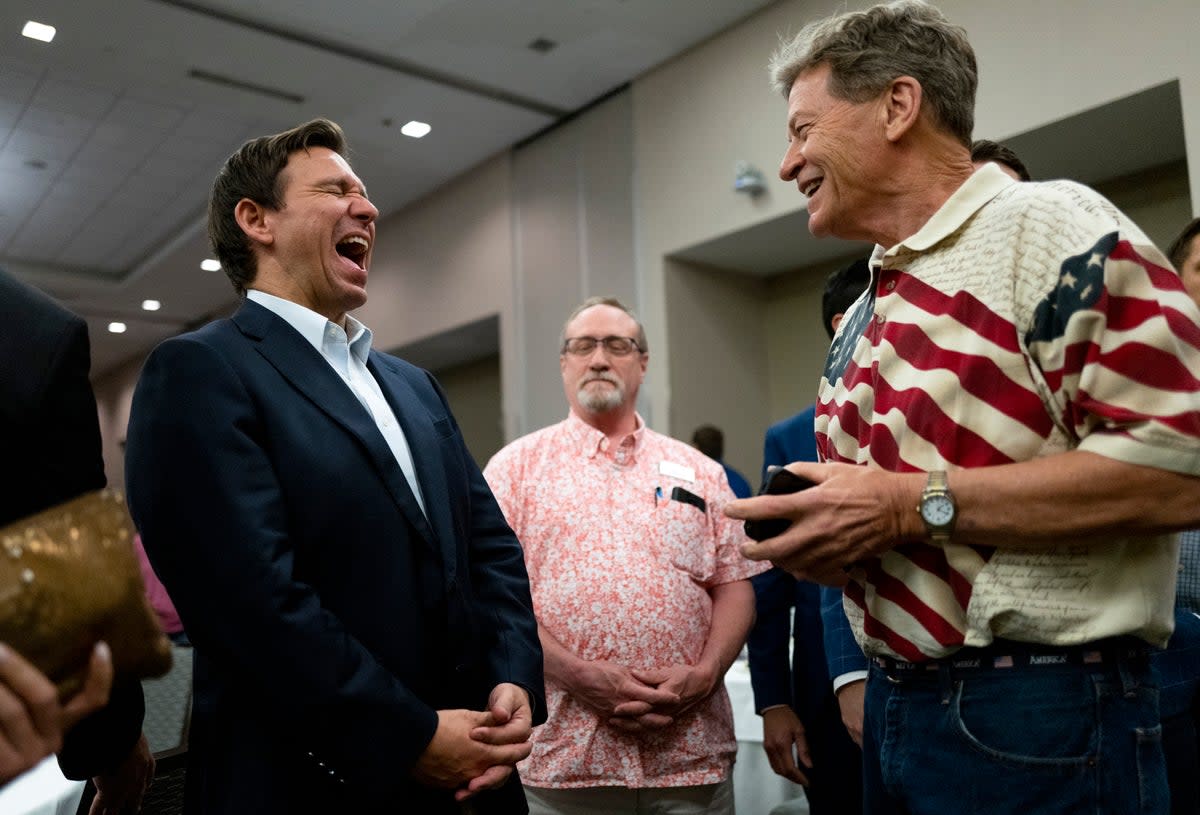 DeSantis laughs with voters at an Iowa GOP receptio in Cedar Rapids, Iowa (Getty Images)