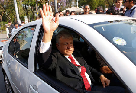 Leftist front-runner Andres Manuel Lopez Obrador waves to supporters after a floral tribute to mark the 212th anniversary of the birth of president Benito Juarez, at the Hemiciclo a Juarez monument in Mexico City, Mexico March 21, 2018. REUTERS/Ginnette Riquelme