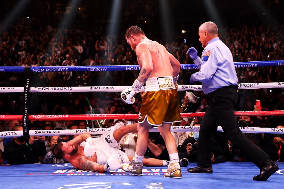 Canelo Alvarez (top) knocks out Caleb Plant in the 11th round (Getty)