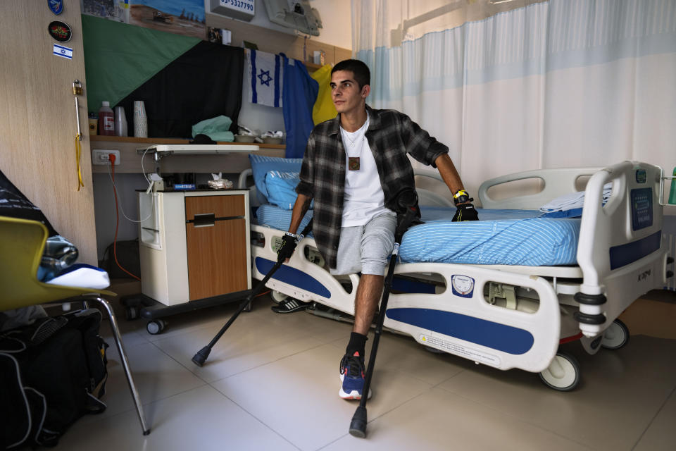 Israeli reservist Igor Tudoran, 27, wounded in the war with Hamas, sits in his room at Sheba hospital's rehabilitation division, in Ramat Gan, Israel, Monday, Dec. 18, 2023. Tudoran was wounded in the Gaza Strip when a missile fired by militants in Gaza slammed into his tank. (AP Photo/Oded Balilty)