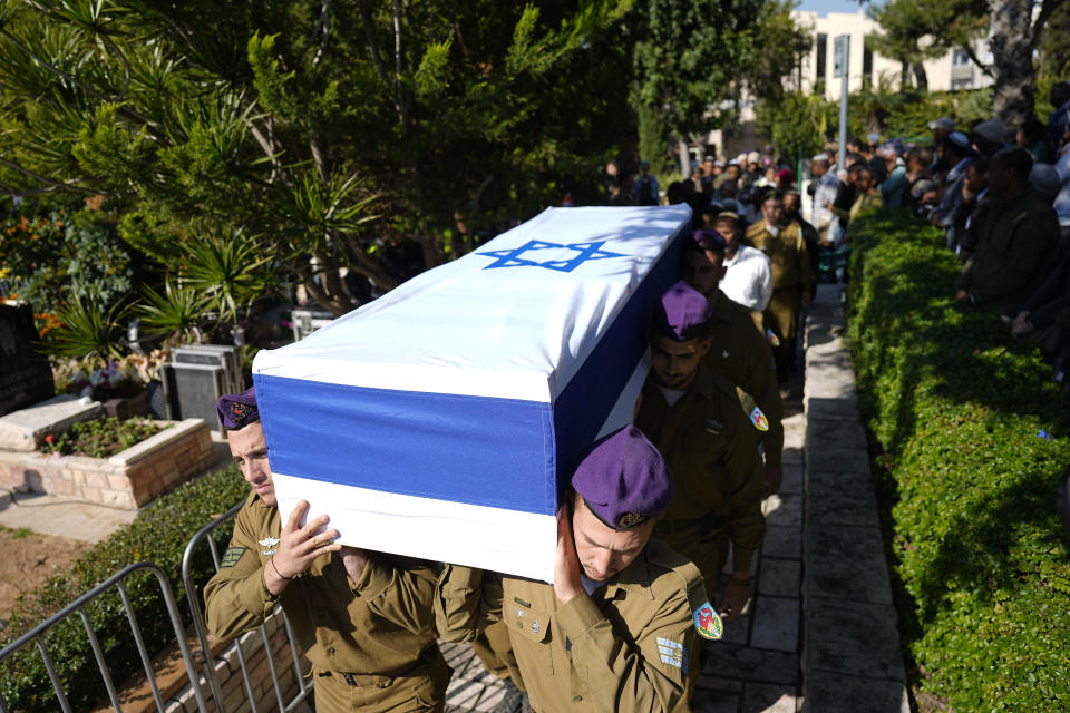 Israeli soldiers carry the casket of Staff sergeant Narya Belete during his funeral in Netanya, Israel, Sunday, Feb. 25, 2024. Belete, 21, was killed during Israel's ground operation in the Gaza Strip, where the Israeli army has been battling Palestinian militants in the war ignited by Hamas' Oct. 7 attack into Israel. (AP Photo/Ariel Schalit)