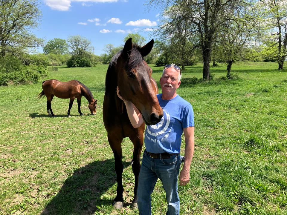 Mark Forrest, Madison County commissioner and owner of a horse boarding business, stands with one of his horses, Pepe. Forrest lost his bid for re-election in the Republican primary in part because of his support for the Oak Run solar project.