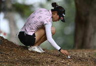 New Zealand's Lydia Ko moves wood chips on the ground as she prepares to hit the ball during the first round of the CP Women's Open golf tournament, Thursday, Aug. 25, 2022, in Ottawa, Ontario. (Justin Tang/The Canadian Press via AP)