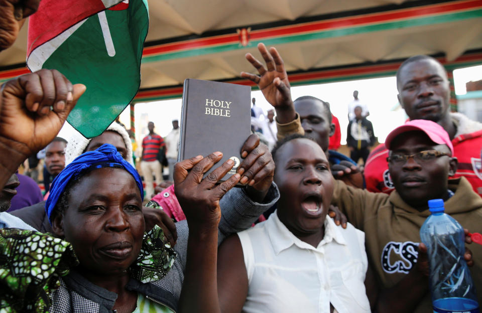 <p>Supporters of Kenyan opposition leader Raila Odinga of the National Super Alliance (NASA) coalition hold a Bible ahead of his planned swearing-in ceremony as the president of the peopleís assembly in Nairobi, Kenya, Jan. 30, 2018. (Photo: Thomas Mukoya/Reuters) </p>