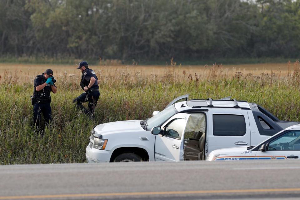 <div class="inline-image__caption"><p>A Royal Canadian Mounted Police officer photographs a pickup truck at the scene where suspect Myles Sanderson was arrested, along Highway 11 in Weldon, Saskatchewan, Canada, on Sept. 7, 2022.</p></div> <div class="inline-image__credit">Lars Hagberg/AFP via Getty Images</div>
