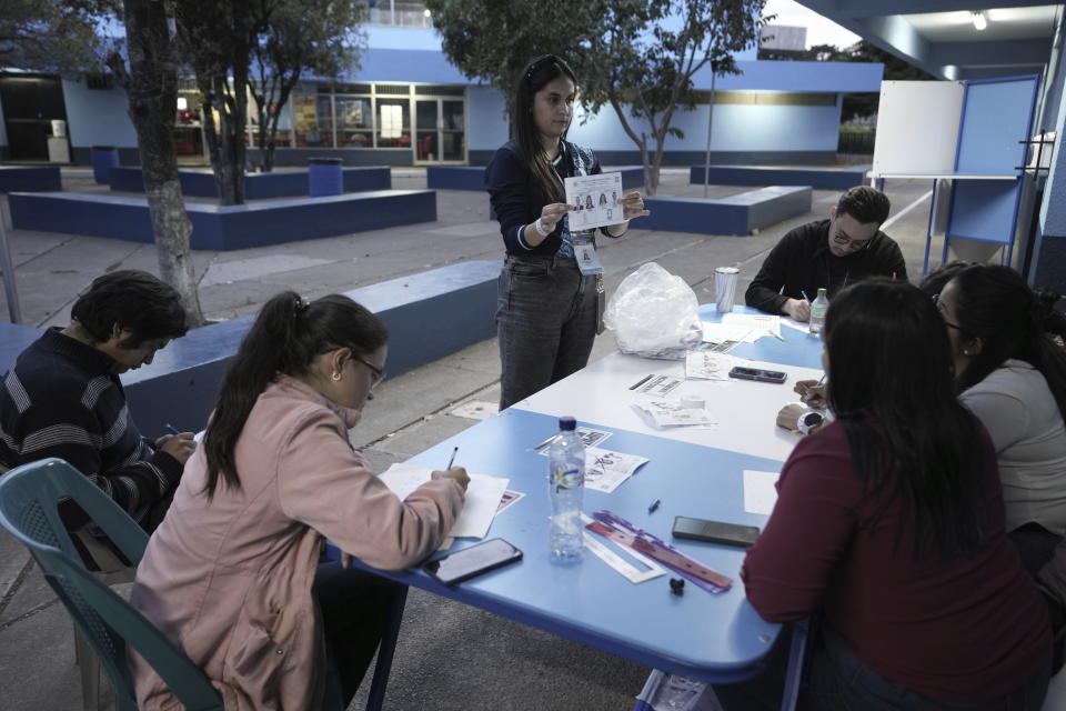 Electoral workers count votes for the runoff presidential election, after polls closed, in Guatemala City, Sunday, Aug. 20, 2023. Bernardo Arévalo, of the Seed Movement party, and former first lady Sandra Torres, of the National Unity of Hope party or UNE, are competing to be the country's next president. (AP Photo/Moises Castillo)