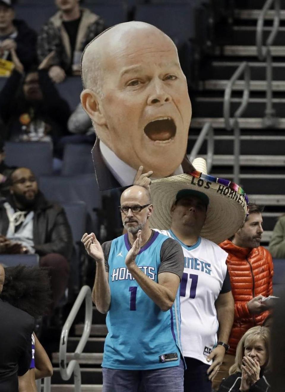 A Charlotte Hornets fan holds up a large photo of coach Steve Clifford during Wednesday’s game against the Washington Wizards. Clifford returned to the bench after being out for several weeks for a health issue.