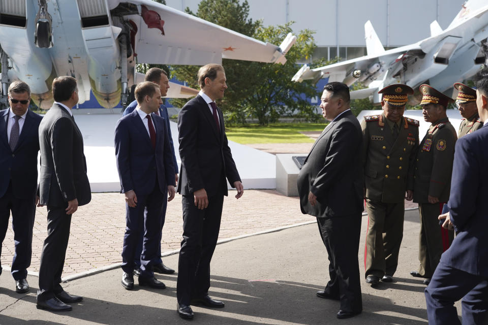 In this photo released by the Khabarovsky Krai region government, North Korean leader Kim Jong Un, centre right, speaks with Deputy Prime Minister and Minister of Trade and Industry Denis Manturov, center left, while visiting a Russian aircraft plant that builds fighter jets in Komsomolsk-on-Amur, about 6,200 kilometers (3,900 miles) east of Moscow, Russia, Friday, Sept. 15, 2023. (Khabarovsky Krai region government via AP)