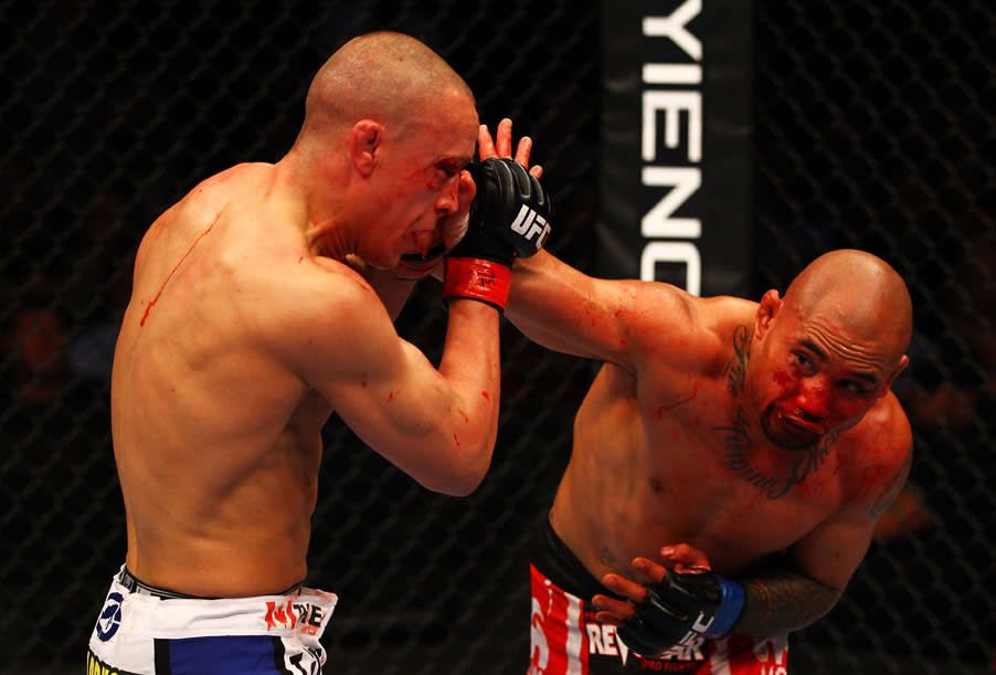 ATLANTA, GA - APRIL 21: Eddie Yagin (R) punches Mark Hominick during their featherweight bout for UFC 145 at Philips Arena on April 21, 2012 in Atlanta, Georgia.