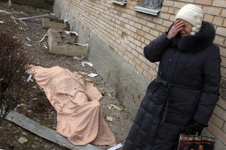 A woman cries near the body of her son, killed during a shelling at the hospital of Donetsk's Tekstilshik district, on Febuary 4, 2015
