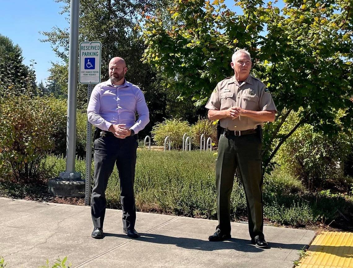 Thurston County Sheriff’s Lt. Cameron Simper, left, and Sheriff John Snaza get ready to hold a news conference on the disappearance of Olympia High School football player Gabriel Davies.