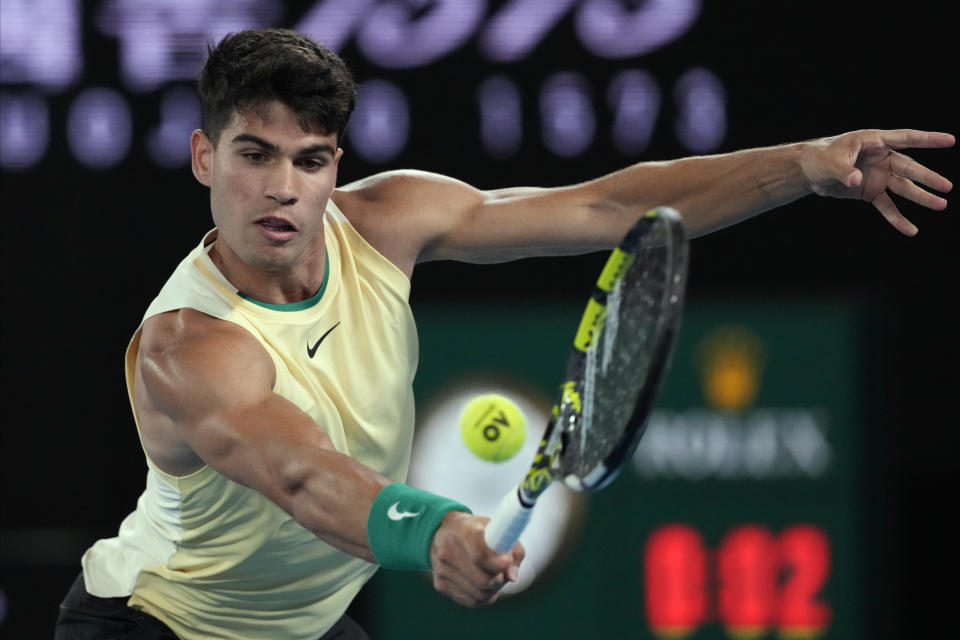 Carlos Alcaraz of Spain plays a backhand return to Richard Gasquet of France during their first round match at the Australian Open tennis championships at Melbourne Park, Melbourne, Australia, Tuesday, Jan. 16, 2024. (AP Photo/Andy Wong)