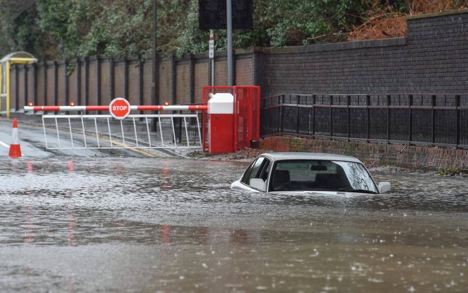 A car is submerged by rising floodwater in St Helens, Lancashire - Richard Long/News Images 