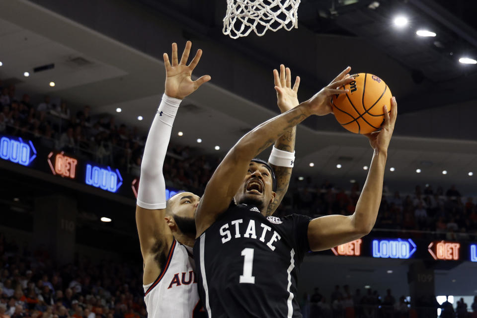 Mississippi State forward Tolu Smith (1) puts up a shot as Auburn forward Johni Broome (4) defends during the first half of an NCAA college basketball game, Saturday, March 2, 2024, in Auburn, Ala. (AP Photo/ Butch Dill)