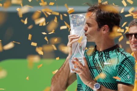 Apr 2, 2017; Key Biscayne, FL, USA; Roger Federer of Switzerland kisses the Butch Buchholz trophy after his match against Rafael Nadal of Spain (not pictured) in the men's singles championship of the 2017 Miami Open at Crandon Park Tennis Center. Mandatory Credit: Geoff Burke-USA TODAY Sports