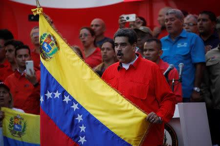 Venezuela's President Nicolas Maduro holds a flag during a rally in Caracas, Venezuela, May 1, 2019. REUTERS/Fausto Torrealba