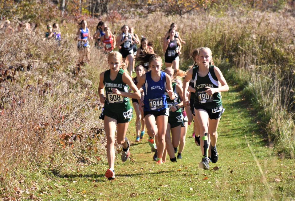 Westmoreland's Emma Szarek (908), Dolgeville's Grace Seeley (1944) and Adirondack's Cora Hinsdill (1907) lead early in the girls' Center State Conference championship cross country race at Herkimer College.