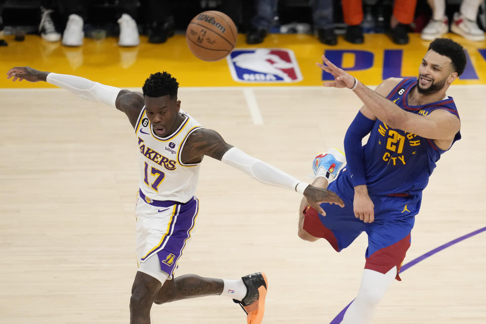 Denver Nuggets guard Jamal Murray, right, passes over Los Angeles Lakers guard Dennis Schroder (17) in the second half of Game 3 of the NBA basketball Western Conference Final series Saturday, May 20, 2023, in Los Angeles. (AP Photo/Ashley Landis)