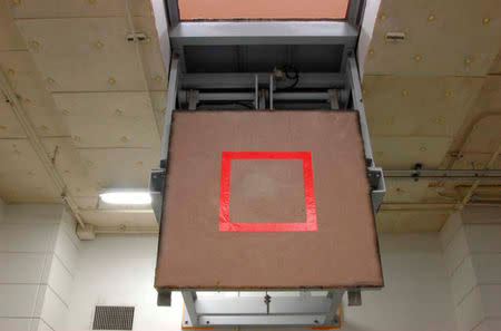 A trap door marked with a red square where an inmate stands, is seen opened at an execution chamber at the Tokyo Detention Center in Tokyo in this undated handout photo released by the Justice Ministry August 27, 2010. Justice Ministry/Handout/File Photo via REUTERS