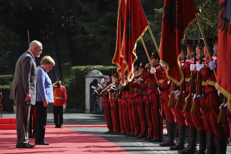 Albanian Prime Minister Edi Rama, left, and the German Chancellor Angela Merkel join the welcome ceremony at the Palace of Brigades in Tirana, Albania, Tuesday, Sept. 14, 2021. Merkel is on a farewell tour of the Western Balkans, as she announced in 2018 that she wouldn't seek a fifth term as Germany's Chancellor. (AP Photo/Franc Zhurda)