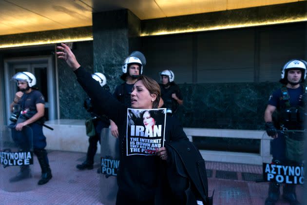 A protester shouts slogans outside the European Commission representative office in Athens during a protest Saturday against the death of Iranian Mahsa Amini. (Photo: Yorgos Karahalis/AP)