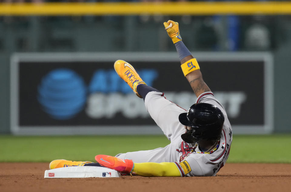 Atlanta Braves' Ronald Acuna Jr. gestures after he stole second base in the seventh inning of a baseball game against the Colorado Rockies, Monday, Aug. 28, 2023, in Denver. (AP Photo/David Zalubowski)