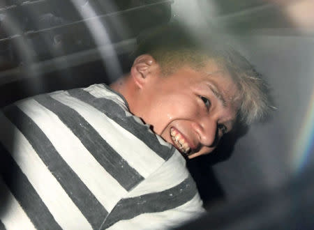 Satoshi Uematsu, suspected of a deadly attack at a facility for the disabled, is seen inside a police car as he is taken to prosecutors, at Tsukui police station in Sagamihara, Kanagawa prefecture, Japan, in this photo taken by Kyodo July 27, 2016. Mandatory credit Kyodo/via REUTERS