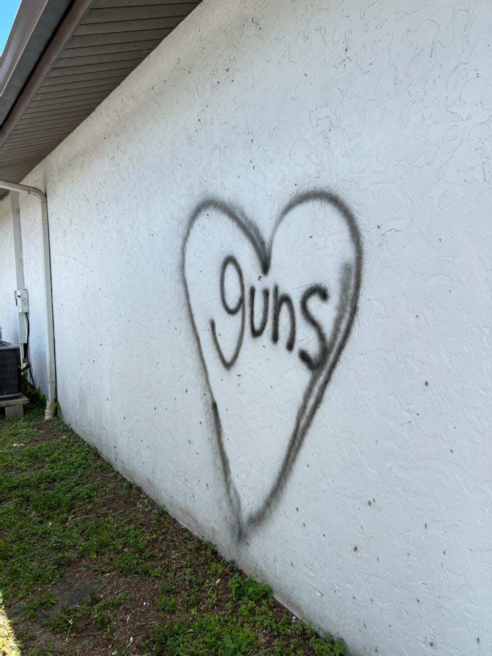 The word "guns" was also spray-painted on the building.