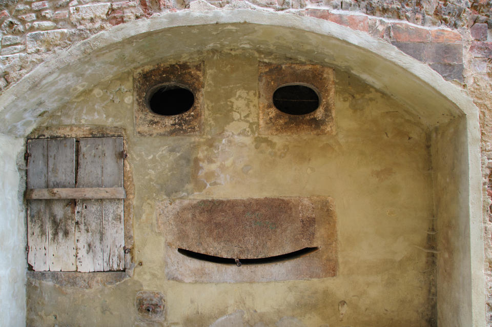 This wall in an old town in Tuscany, Italy, illustrates the phenomenong of Pareidolia, or seeing faces in things.