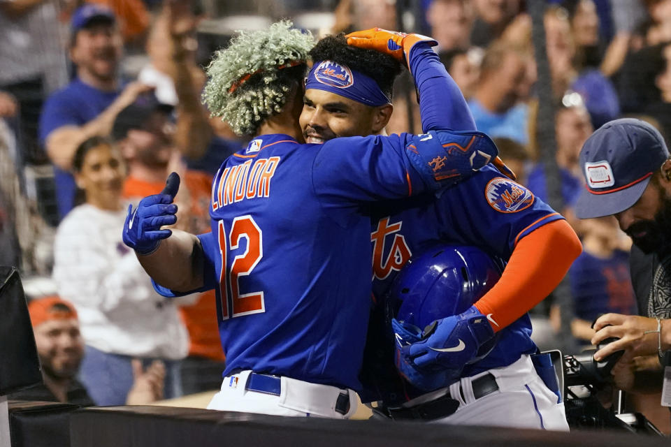 New York Mets' Nick Plummer celebrates with Francisco Lindor (12) after hitting a game-tying home run for his first major league hit during the ninth inning of a baseball game against the Philadelphia Phillies, Sunday, May 29, 2022, in New York. (AP Photo/Mary Altaffer)