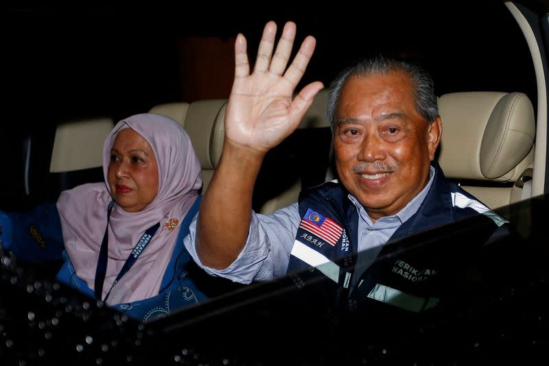 Malaysian former Prime Minister and Perikatan Nasional chairman Muhyiddin Yassin waves as leaves after Malaysia's 15th general election in Shah Alam