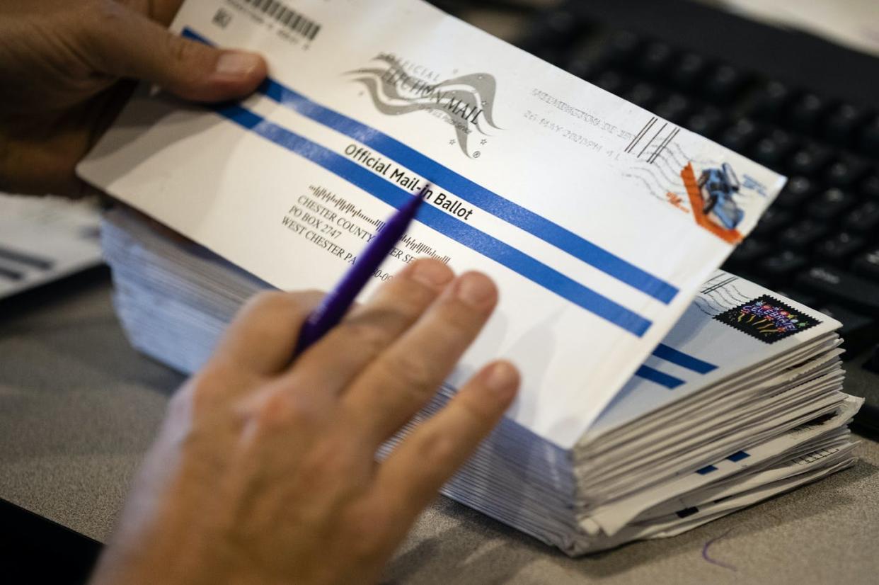 <span class="caption">A Pennsylvania election worker processes mailed-in ballots for the state's primary election in May 2020.</span> <span class="attribution"><a class="link " href="http://www.apimages.com/metadata/Index/Virus-Outbreak-Election-2020-Pennsylvania/b454cee8c1af4bd1b1f0044869707605/45/0" rel="nofollow noopener" target="_blank" data-ylk="slk:AP Photo/Matt Rourke;elm:context_link;itc:0;sec:content-canvas">AP Photo/Matt Rourke</a></span>