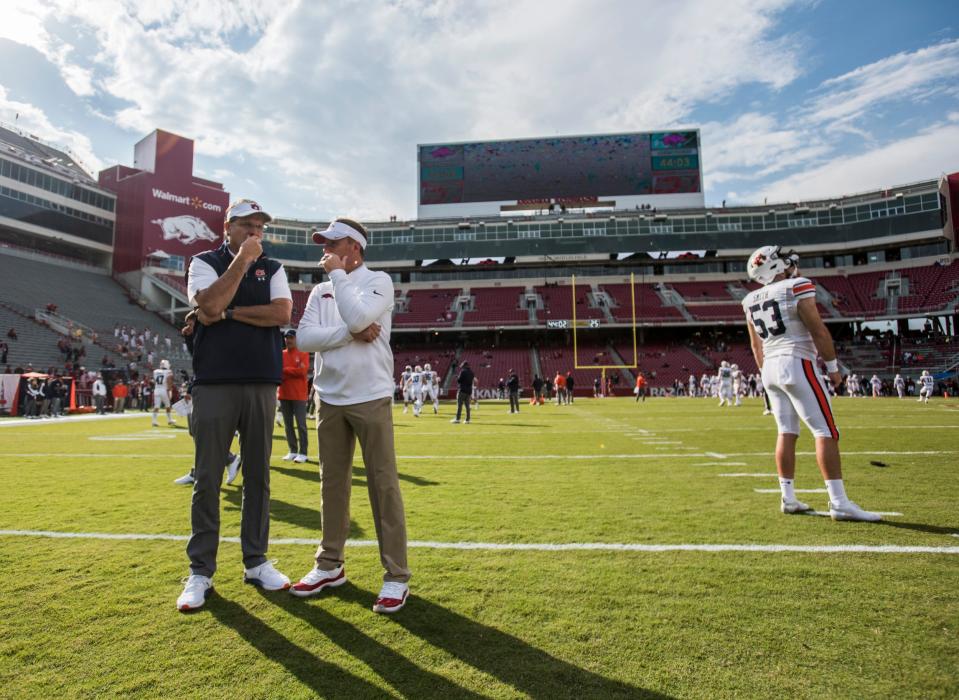 Arkansas head coach Chad Morris and Auburn's Gus Malzahn chat during pregame warmups of their 2019 game in Fayetteville. Morris lasted not quite two full seasons with the Razorbacks but has re-emerged as Texas State's passing game coordinator under G.J. Kinne, whom Morris coached as a quarterback at Tulsa.