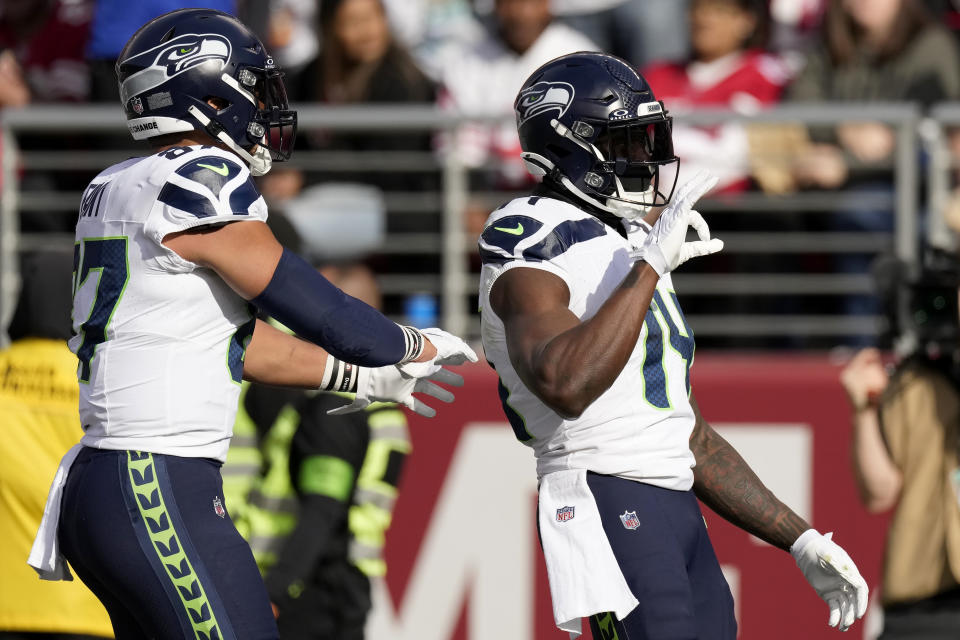 Seattle Seahawks wide receiver DK Metcalf, right, celebrates with tight end Noah Fant after scoring against the San Francisco 49ers during the first half of an NFL football game in Santa Clara, Calif., Sunday, Dec. 10, 2023. (AP Photo/Godofredo A. Vásquez)