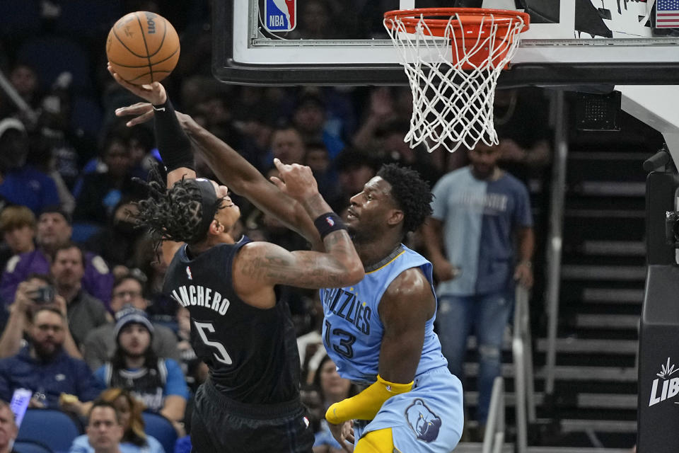 Orlando Magic's Paolo Banchero (5) attempts to shoot over Memphis Grizzlies' Jaren Jackson Jr. (13) during the second half of an NBA basketball game, Thursday, Jan. 5, 2023, in Orlando, Fla. (AP Photo/John Raoux)