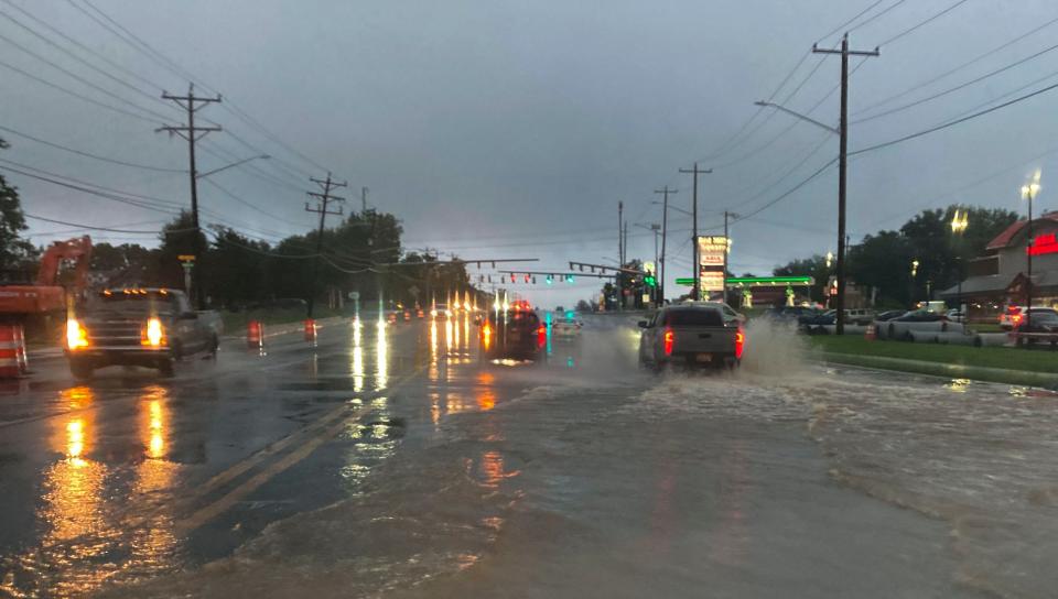 Capitol Trail is flooded near Polly Drumond Hill Road where a drain has had trouble dealing with torrents of rain in the aftermath of powerful storms shortly after 7 p.m., Thursday, August 8, 2024.