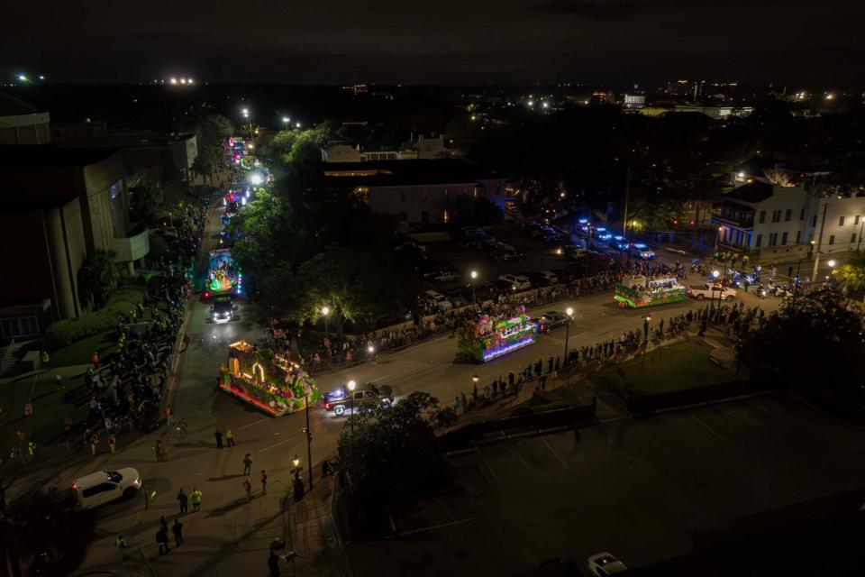 Floats make their way through crowded streets in Mobile.