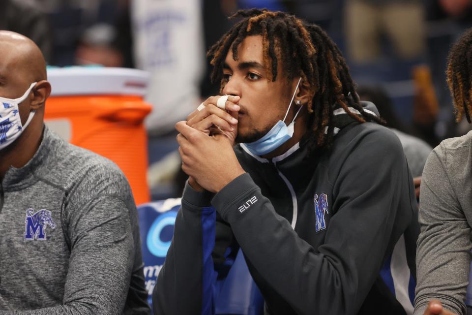 Memphis Tigers guard Emoni Bates sits on the bench with tape on the fingers of his right hand as his team takes on the Tulsa Golden Hurricane at FedExForum on Tuesday, Jan. 4, 2022.