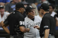 Chicago White Sox's Tony La Russa, center, reacts as he talks with umpires during the fifth inning of a baseball game against the Milwaukee Brewers, Saturday, July 24, 2021, in Milwaukee. (AP Photo/Aaron Gash)