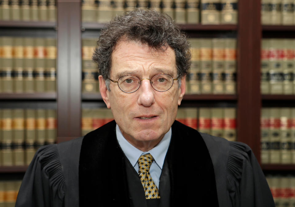 FILE – In this Jan. 11, 2018, file photo, U.S. District Judge Dan Polster poses for a portrait in his office in Cleveland. . Lawsuits filed by two Ohio counties against retail pharmacy chains CVS, Walgreens, Rite Aid, Walmart and Giant Eagle claiming their opioid dispensing practices flooded communities with pain pills and were a a public nuisance can continue after Polster, a federal judge in Cleveland, denied the chains' motion to dismiss the complaints in a ruling Thursday, Aug. 6, 2020. (AP Photo/Tony Dejak, File)