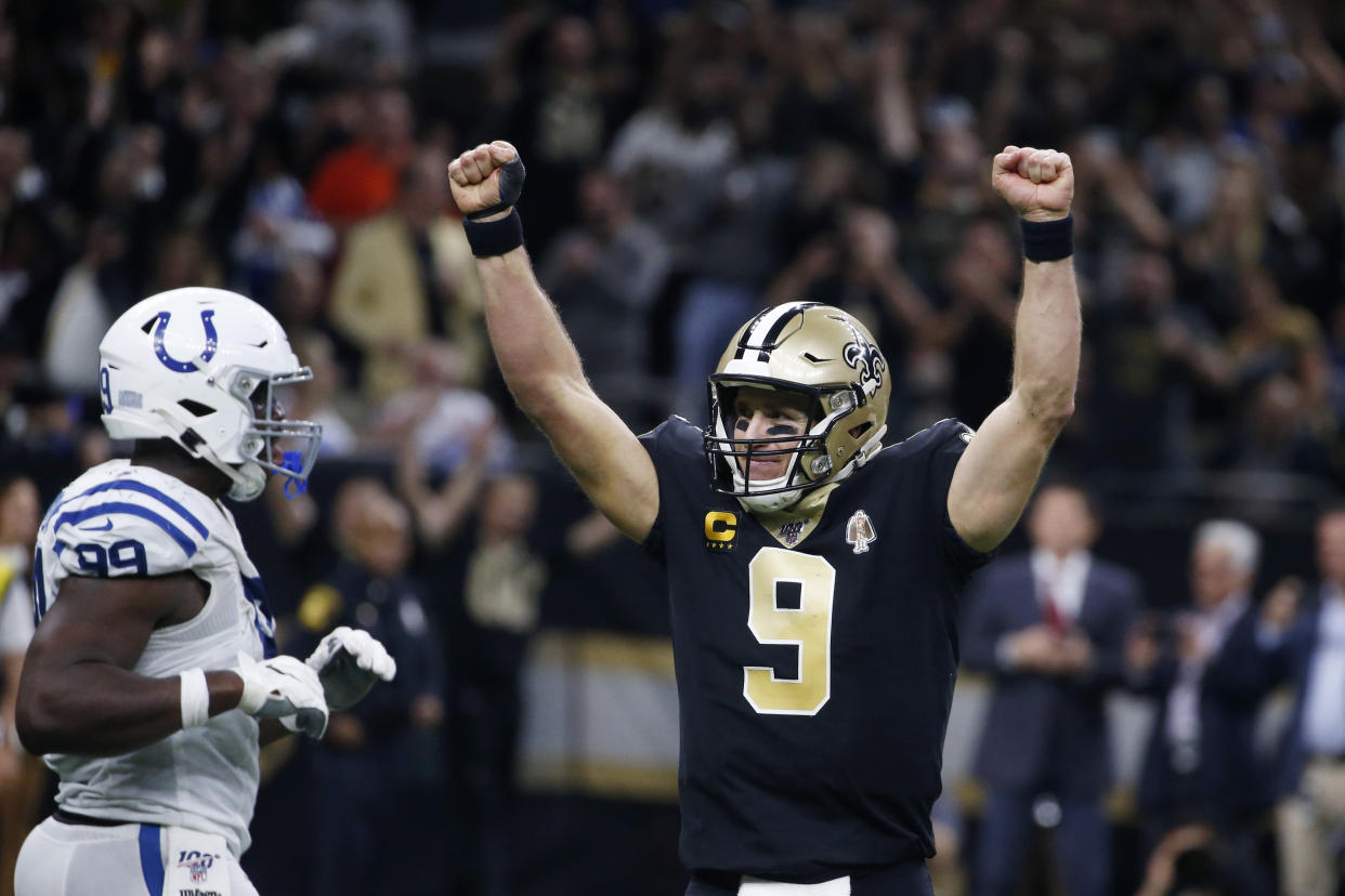 New Orleans Saints quarterback Drew Brees (9) celebrates his touchdown pass to tight end Josh Hill, which broke the NFL record for career touchdown passes, surpassing Peyton Manning. (AP Photo/Butch Dill)