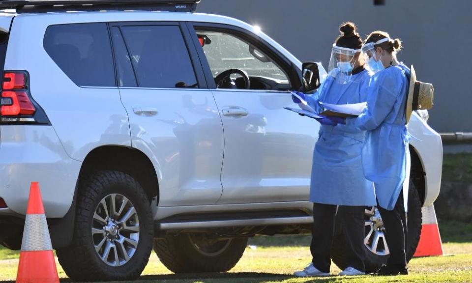 Healthcare workers test members of the public at a pop-up Covid-19 testing clinic at Indooroopilly state high school in Brisbane on Wednesday.