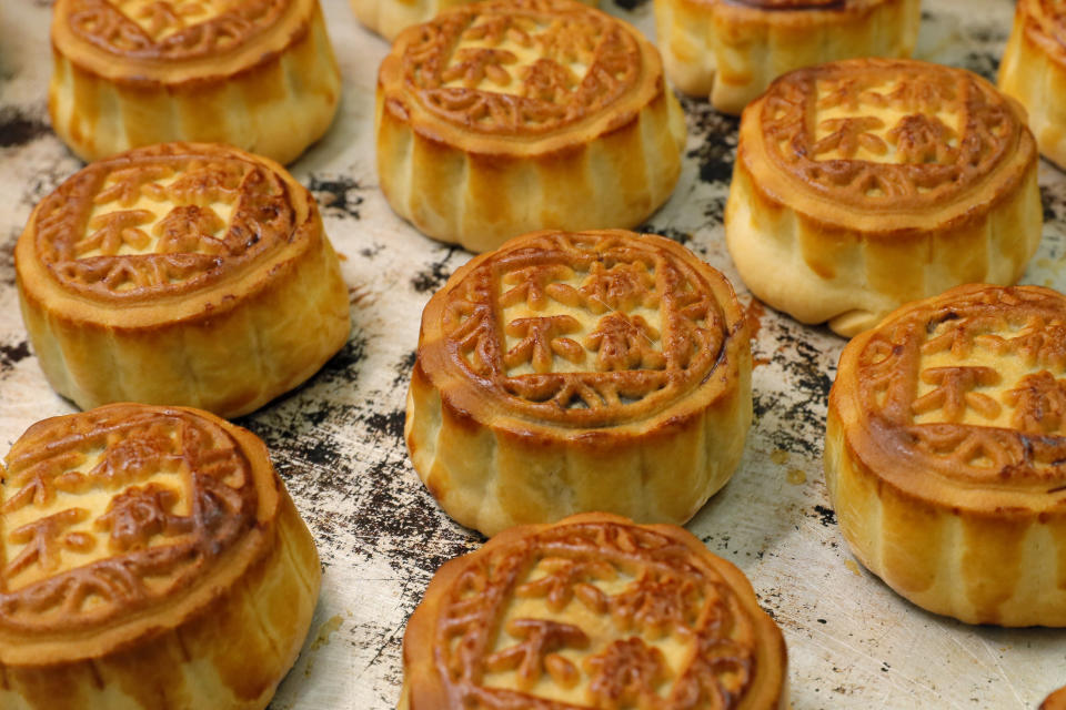 In this Aug. 9, 2019 photo, mooncakes with Chinese words "No withdrawal, no dispersal" are placed on the table at Wah Yee Tang bakery in Hong Kong. This year, a Hong Kong bakery is busy making mooncakes inscribed with wordings related to the recent political movement on the extradition bill. Wah Yee Tang bakery offered pro-protest baked goods stamped with the messages such as "No withdrawal, no dispersal", "Be water", and "Hong Kong people". These political-themed mooncake has attracted people across various district to visit the shop and buy the mooncakes to share with their friends. In the past 12 weeks, Hong Kong has various protests related to the withdrawal of the extradition bill. (AP Photo/Kin Cheung)