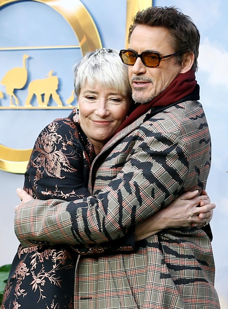 Cast members Robert Downey Jr. and Emma Thompson hug (REUTERS)