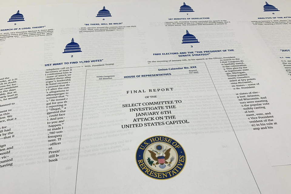 Pages from the final report released by the House select committee investigating the Jan. 6 attack on the U.S. Capitol, is photographed Thursday, Dec. 22, 2022. (AP Photo/Jon Elswick)