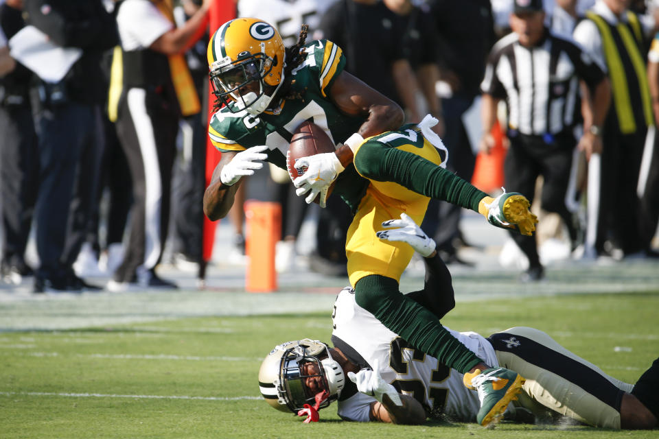 Green Bay Packers wide receiver Davante Adams (17) catches a pass as New Orleans Saints cornerback Marshon Lattimore, lower left, tries to stop him during the first half of an NFL football game, Sunday, Sept. 12, 2021, in Jacksonville, Fla. (AP Photo/Stephen B. Morton)