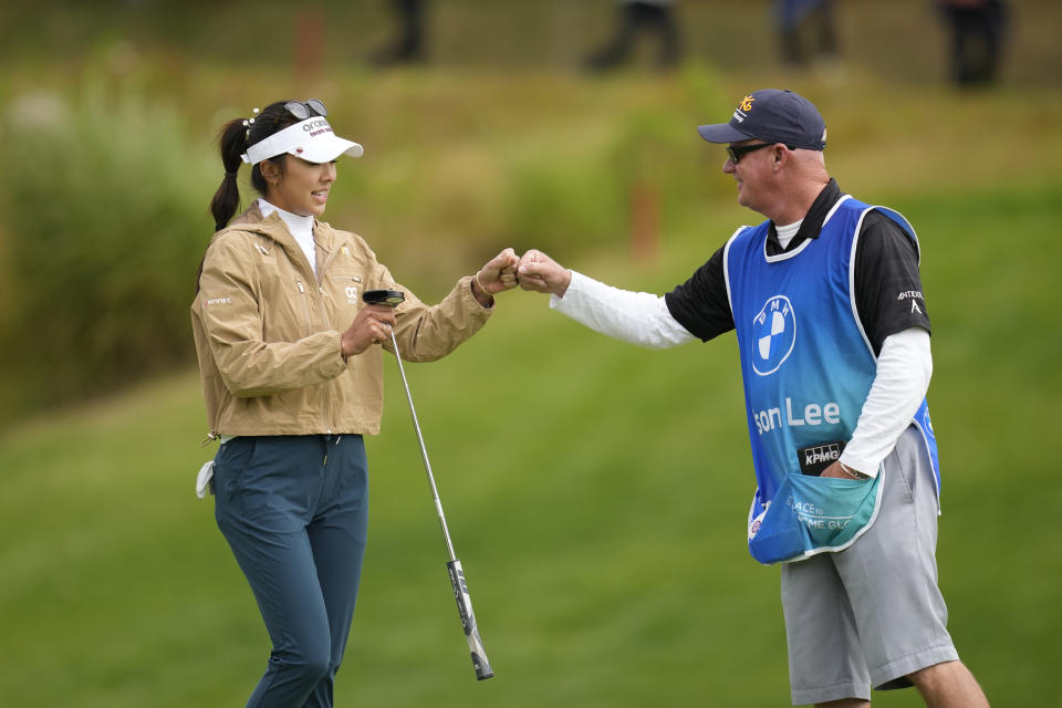 Alison Lee of the United States gets a fist bump from her caddie after making a putt on the seventh hole during the final round of the BMW Ladies Championship at the Seowon Hills Country Club in Paju, South Korea, Sunday, Oct. 22, 2023. (AP Photo/Lee Jin-man)
