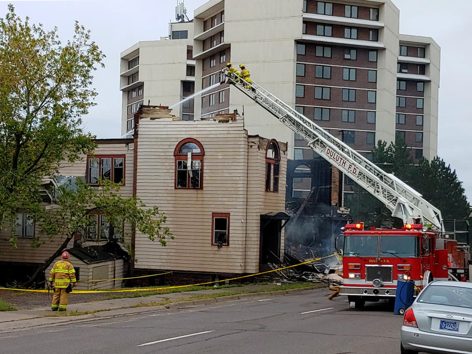 Firefighters work the scene of an overnight fire that engulfed and destroyed a synagogue in downtown Duluth, Minn., Monday, Sept. 9, 2019. (Brooks Johnson/Star Tribune via AP)