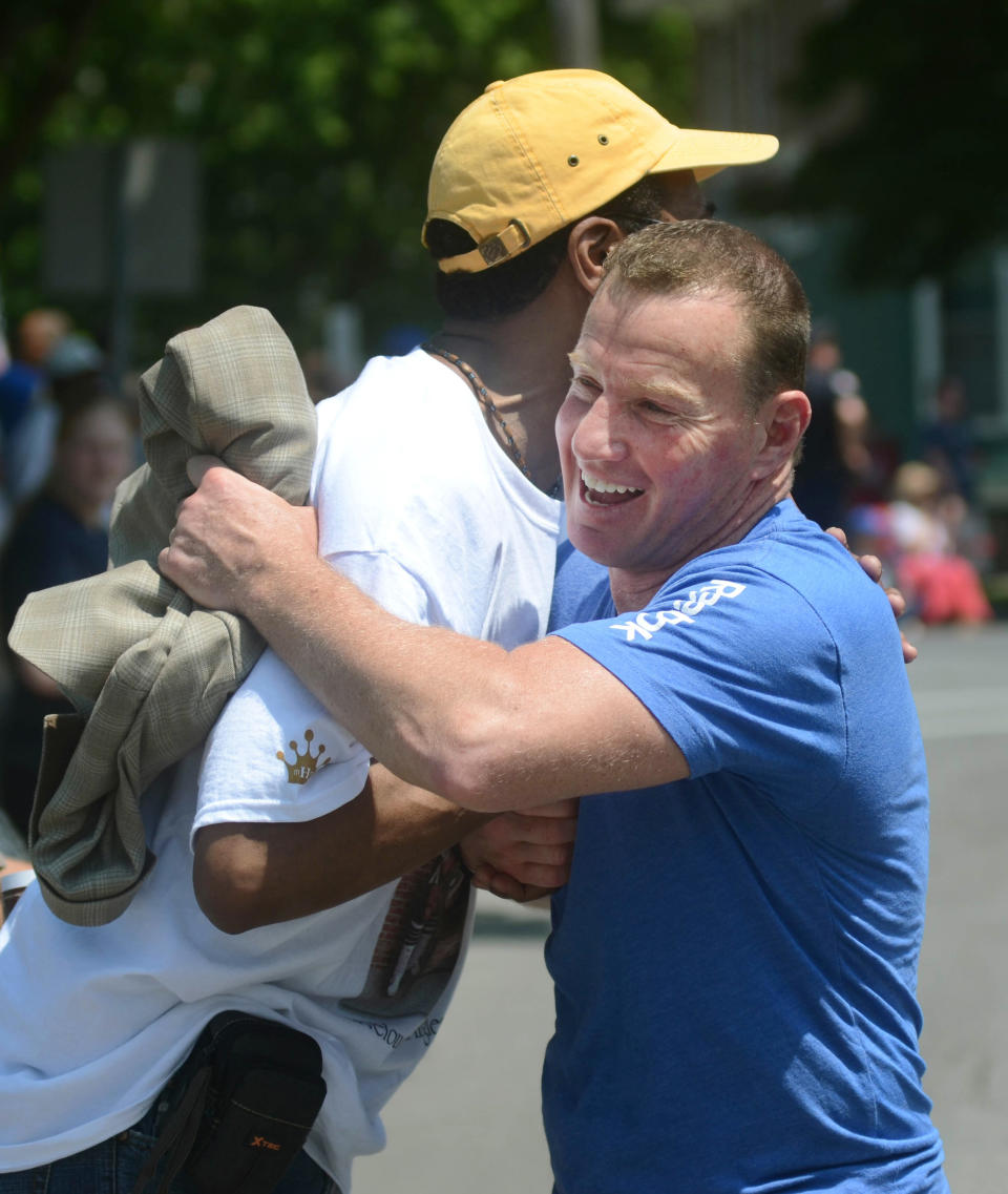 Retired boxer Micky Ward, right, is greeted by fan Linwood Jackson during the International Boxing Hall of Fame induction parade in Canastota, N.Y., Sunday, June 10, 2012. (AP Photo/Heather Ainsworth)