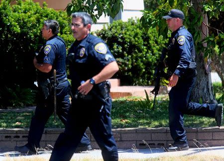 Police take positions at the scene of an armed standoff with a man with a high powered rifle who is holding hostages in Chula Vista, California May 28, 2015. REUTERS/Sandy Huffaker